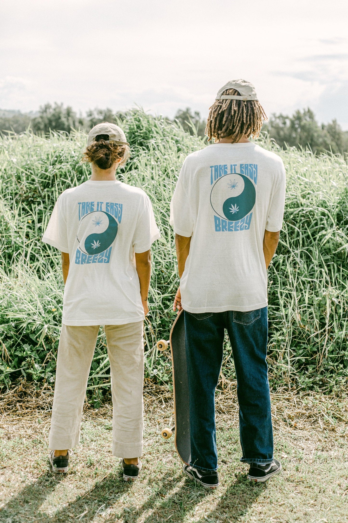 Two skaters model in Byron Bay field in white oversized hemp t shirts